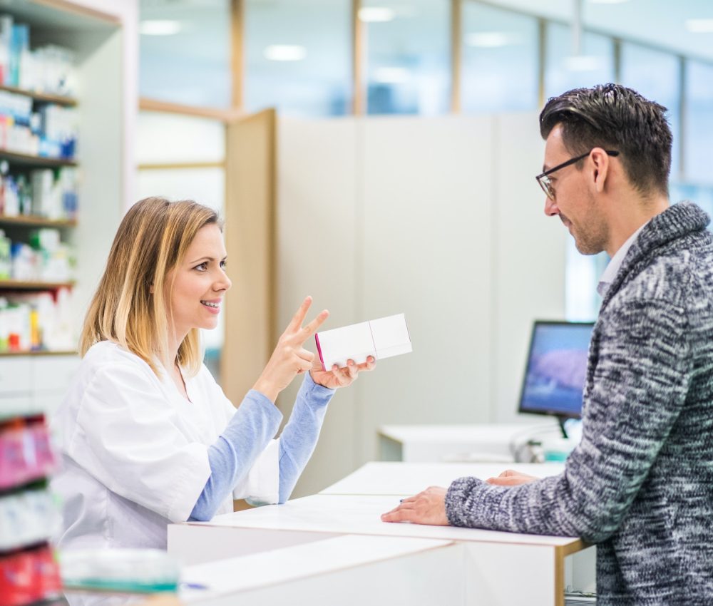 female-pharmacist-serving-a-male-customer-.jpg